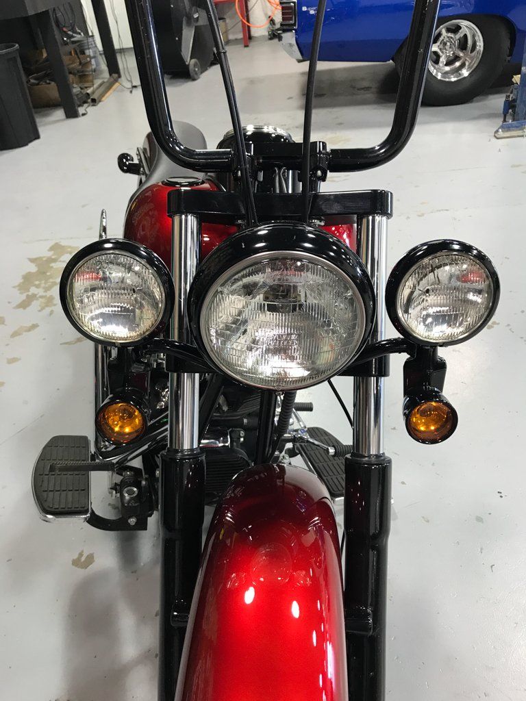 close up of customized red and black chopper headlights