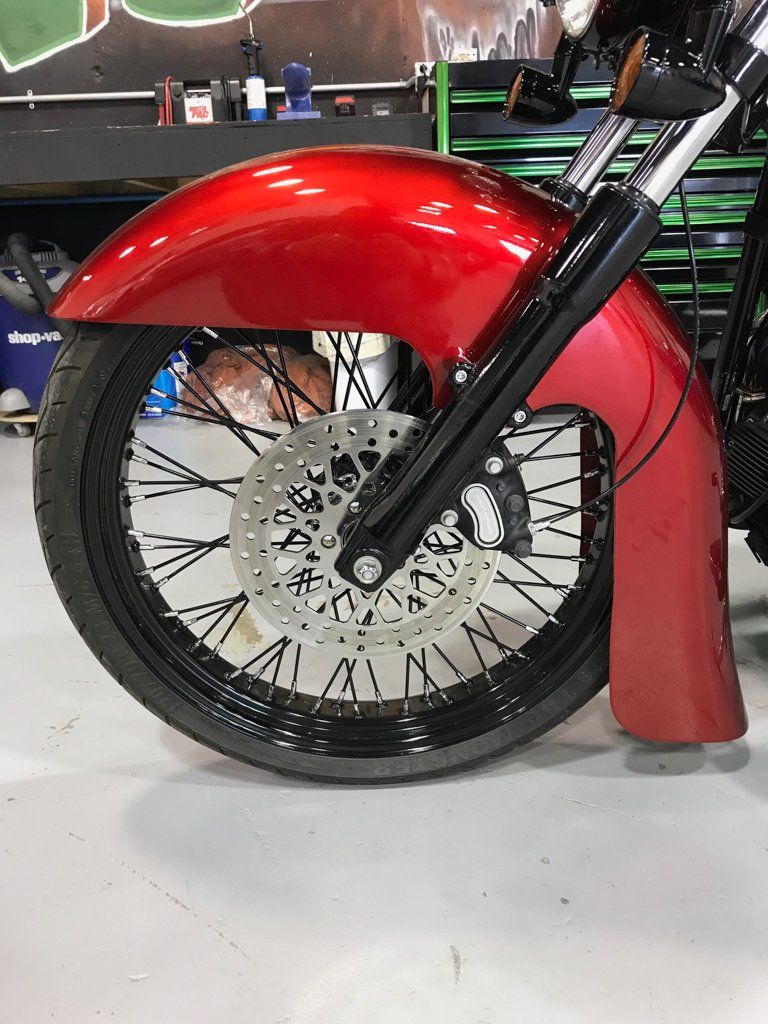 side view of customized red and black chopper front fender