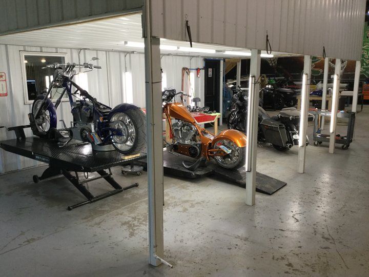 line up of custom motorcycle on service bay