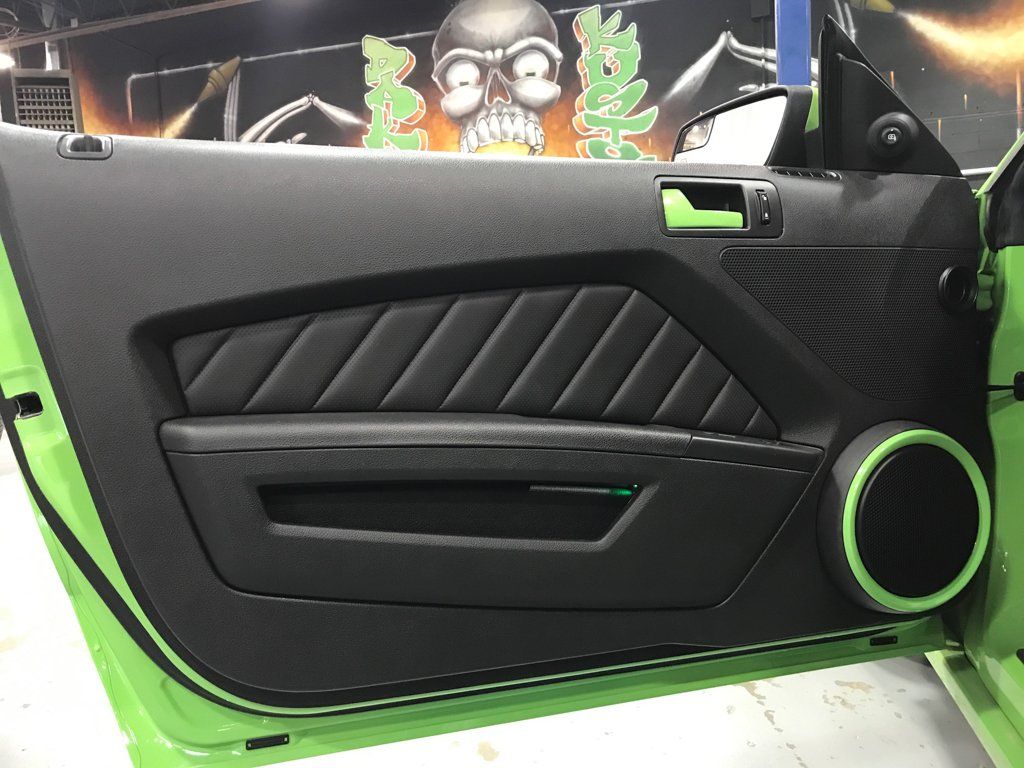 closeup of customized door with green handle with dakota kustomz custom art in background