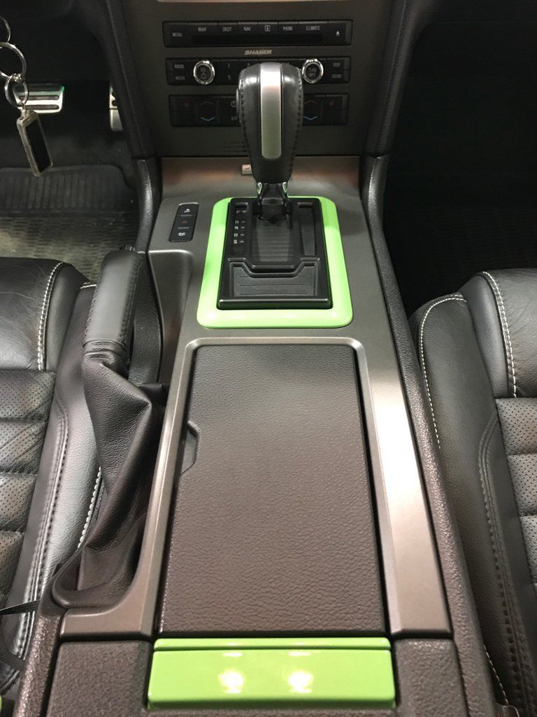 green and black customized central console and central storage unit