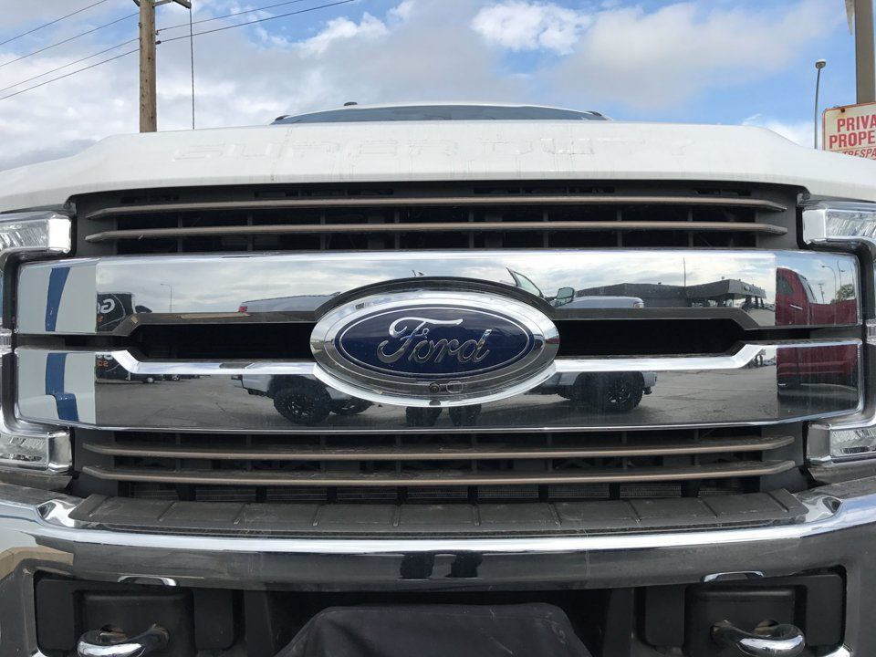 close up of chrome ford logo on pickup truck