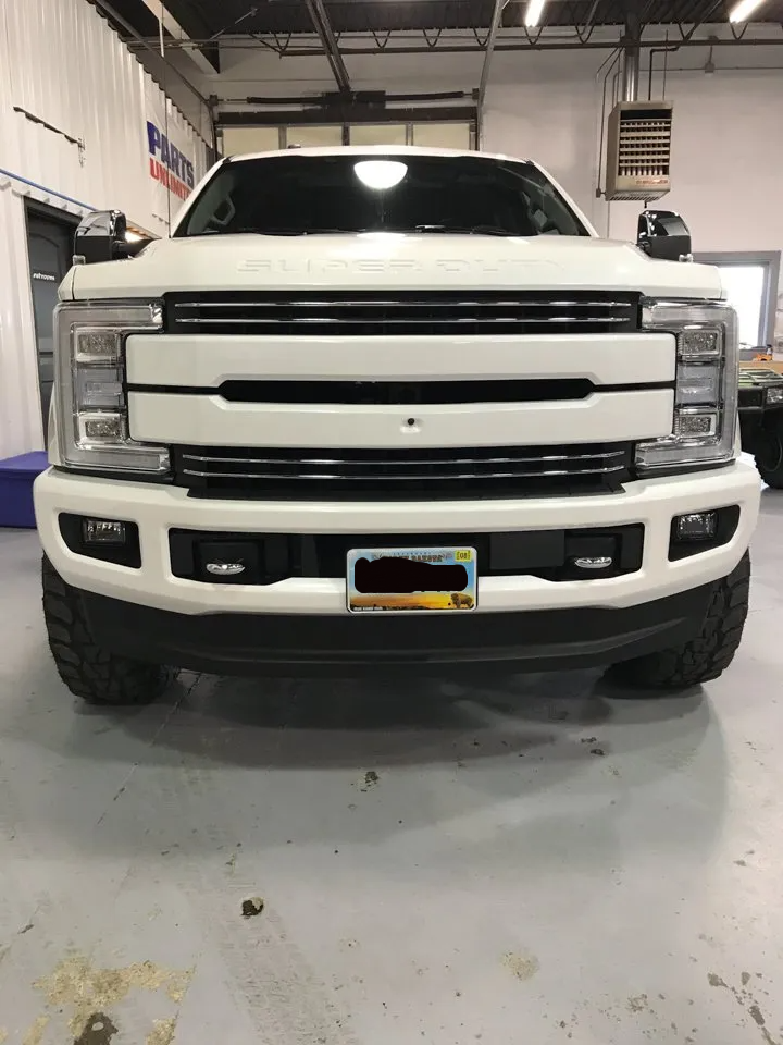 front view of custom white 2017 Ford F350 Diesel Dakota Kustomz Truck in garage