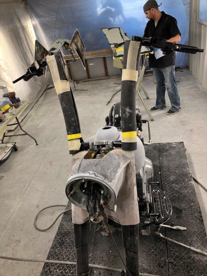 black chopper stripped of paint and headlight removed