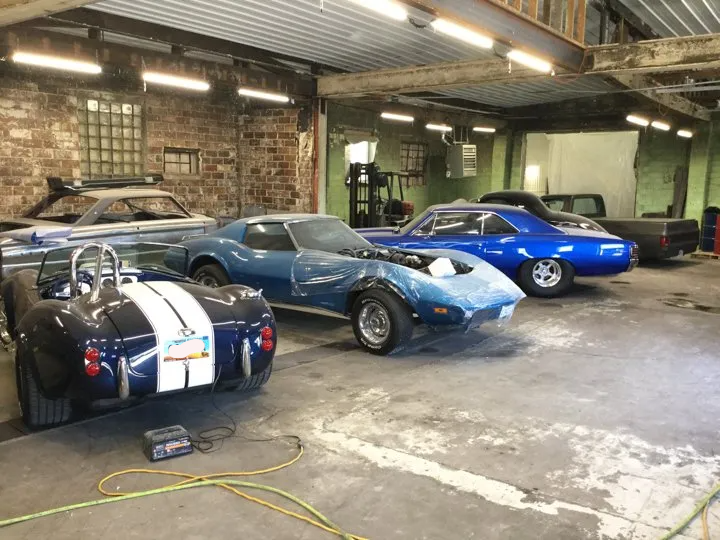 line up of custom cars shelby chevy chevelle and corvette