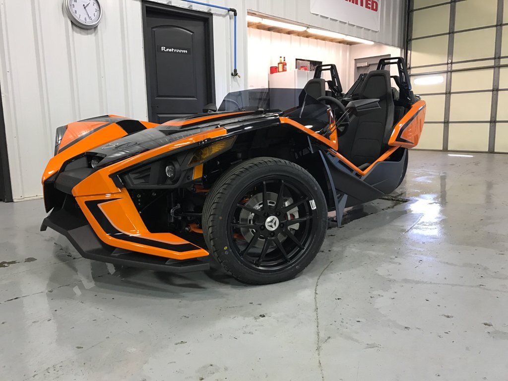 custom orange and black polaris slingshot side view
