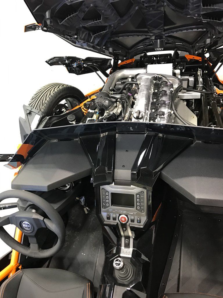 custom orange and black polaris slingshot interior with hood up