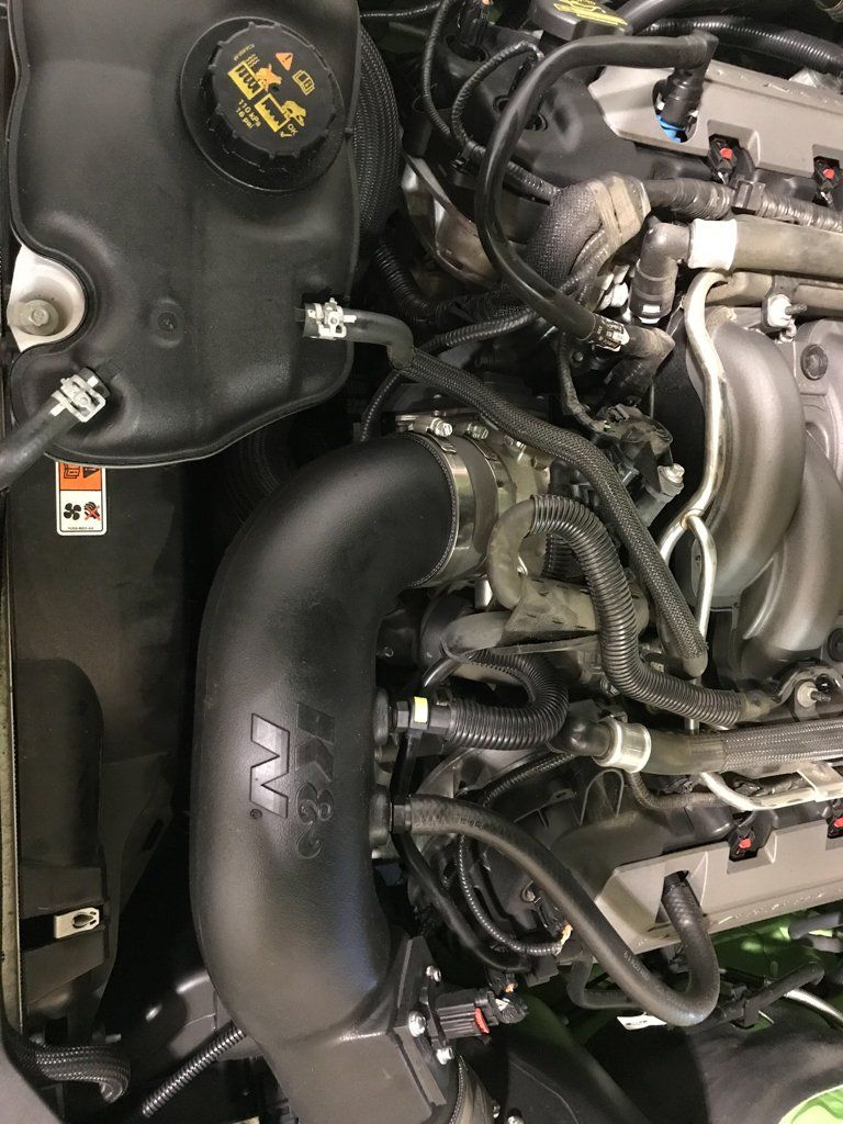 side view of car engine and coolant tank