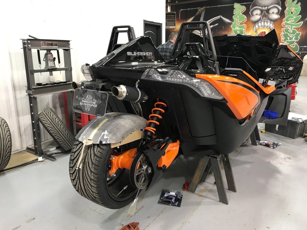 custom orange and black polaris slingshot suspended