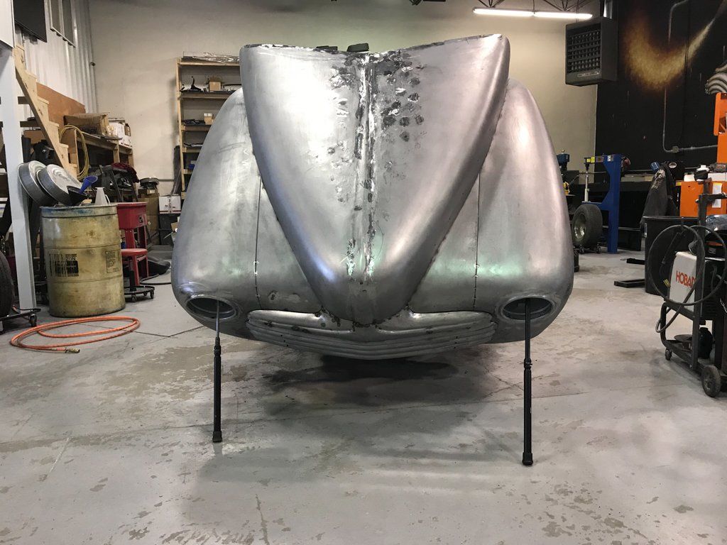 car hood opened with spokes coming out of the headlights