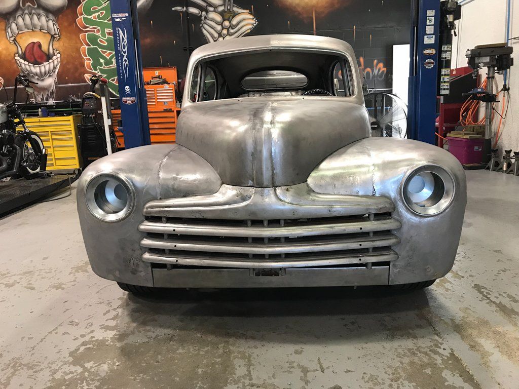 front view of sedan with paint stripped