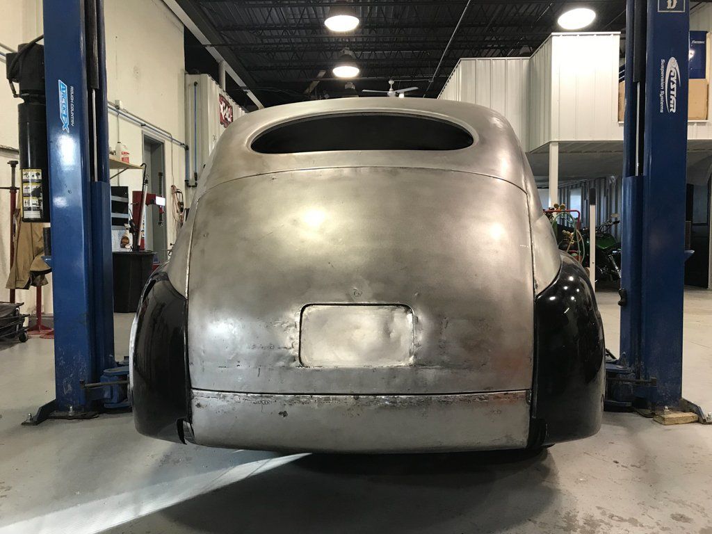 rear view of sedan with license plate removed on service bay