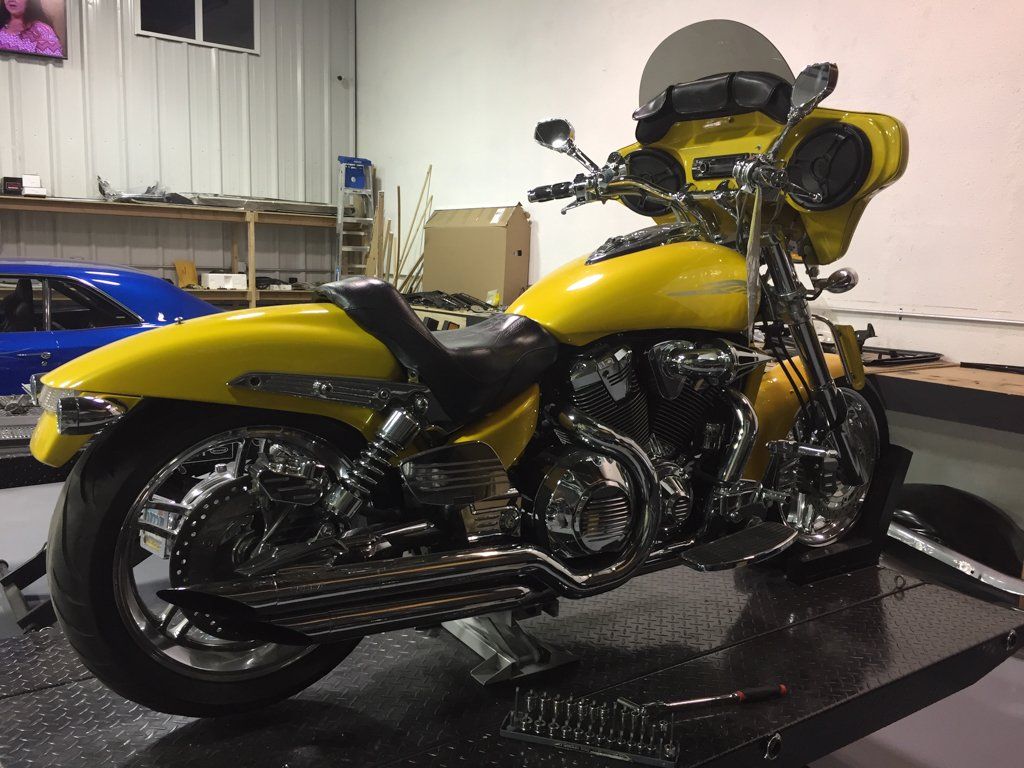 rear view of yellow motorcycle on direct life service bay