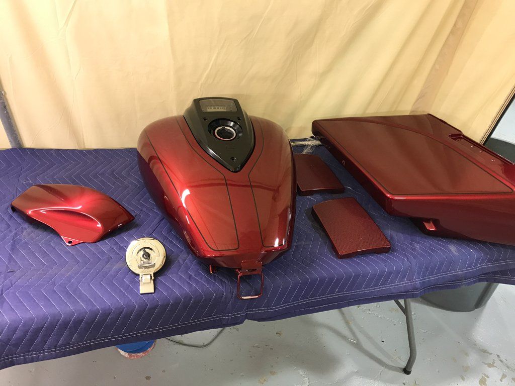 red motorcycle parts laid out on table