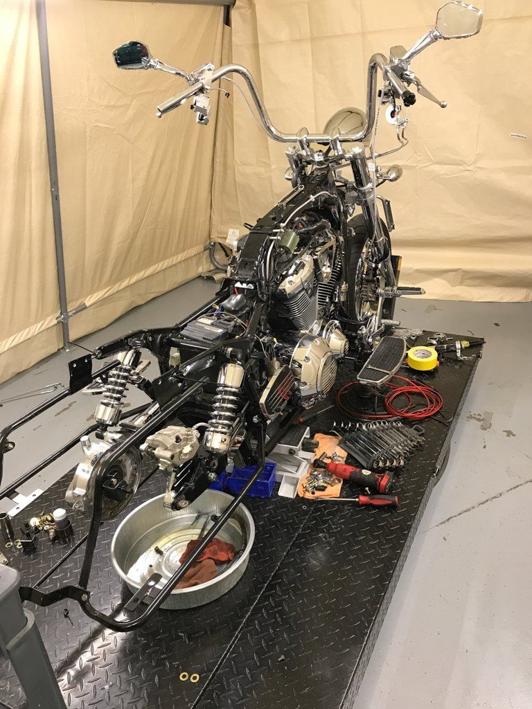 motorcycle with parts removed on workbench
