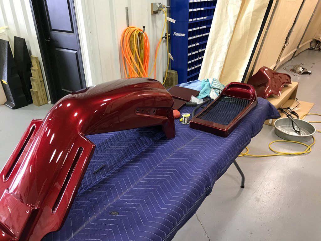 motorcycle parts removed and laid out on table