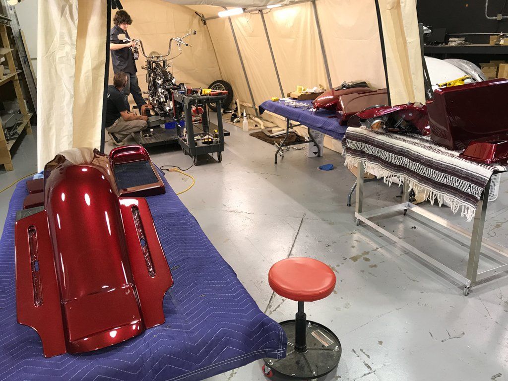 motorcycle parts removed and laid out on table