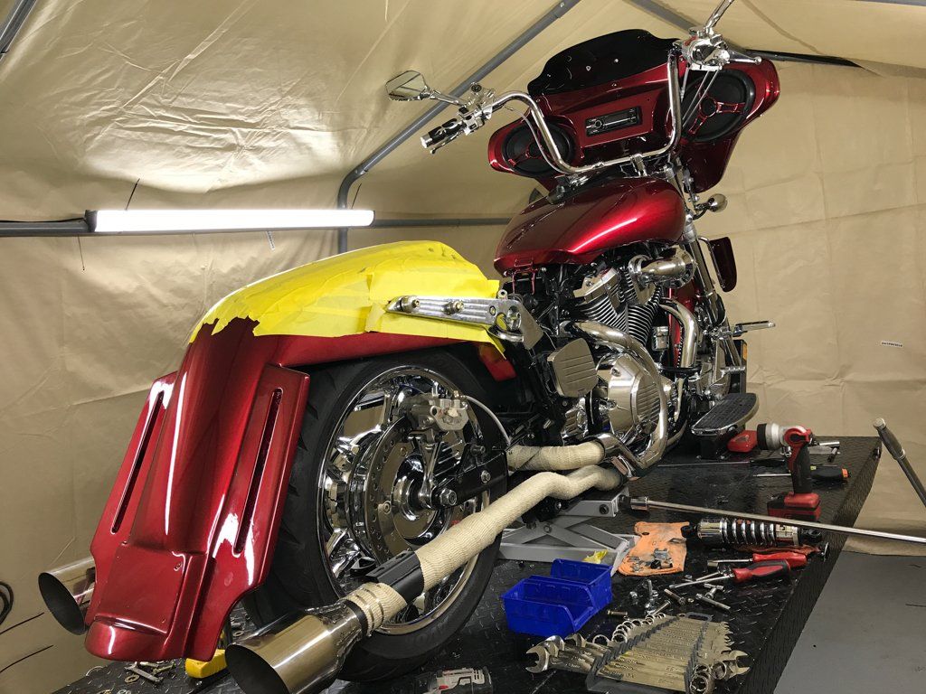 rear view of motorcycle with yellow tape on rear fender