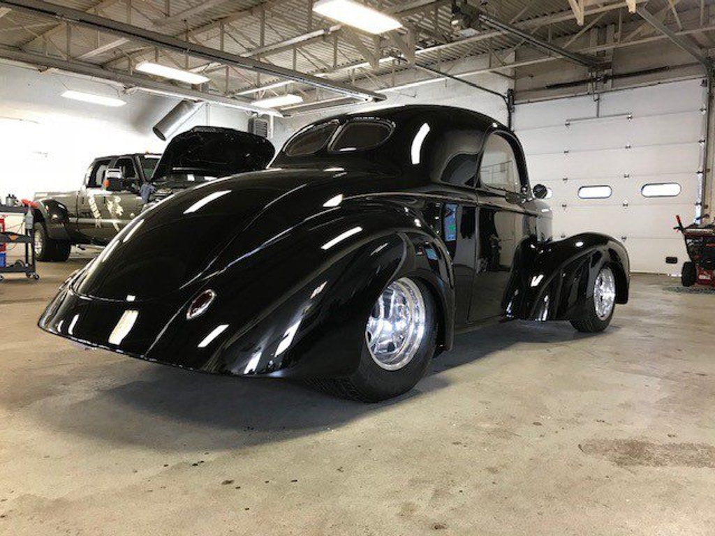 rear side profile view of custom black 1941 willys coupe