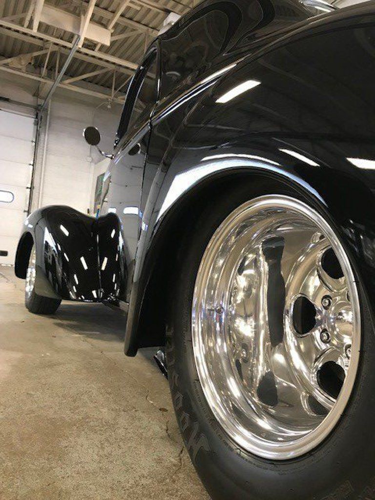 close up of chrome wheels on custom black 1941 willys coupe