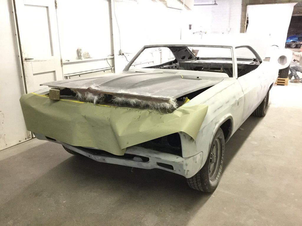 car hood opened ajar with cloth and paper