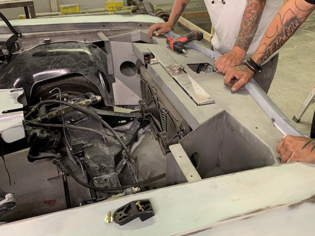 mechanics inspecting inernals of car