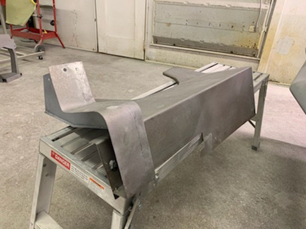 painted car part on ground