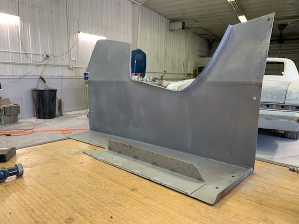 painted car part on workbench