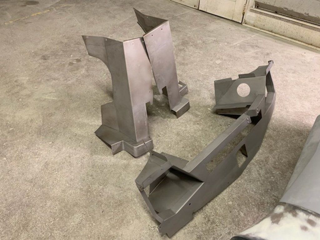 more painted car parts on ground