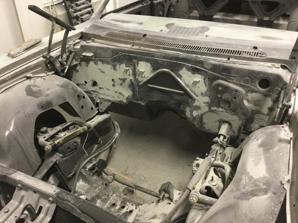 another view of car internals with no engine, parts exposed