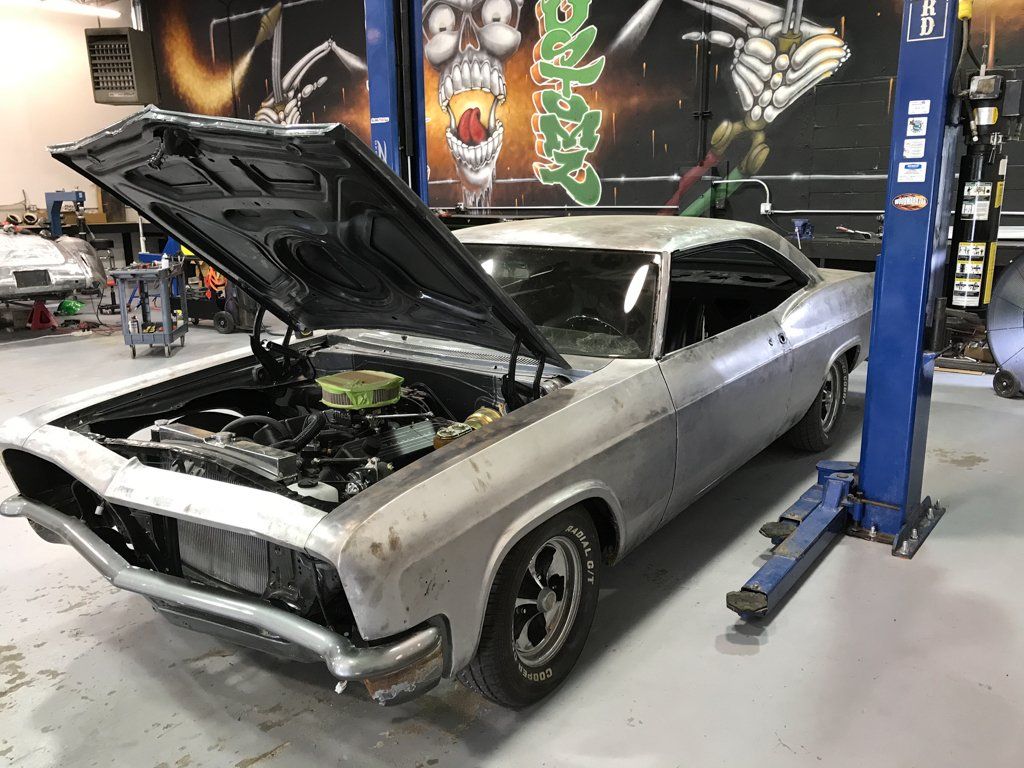 side front view of car with hood open