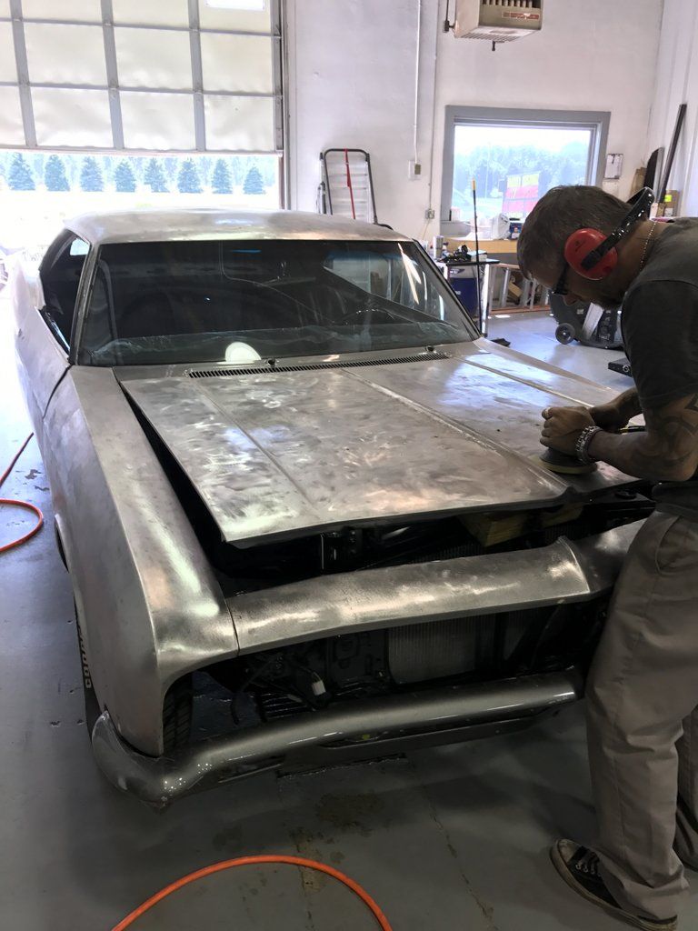 wider view of detailer buffering car hood