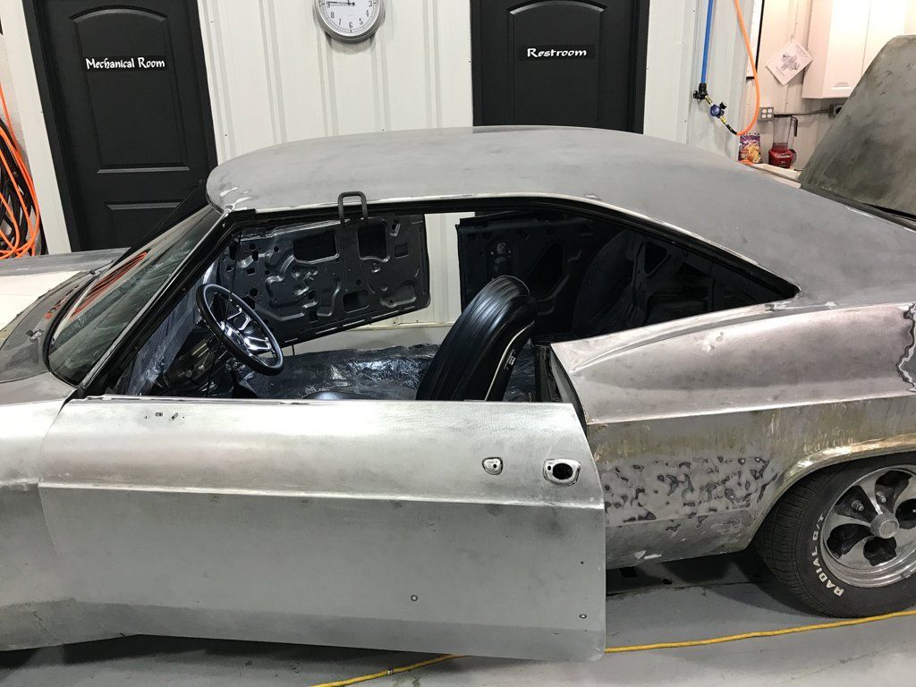 side view of car with door open and handle missing