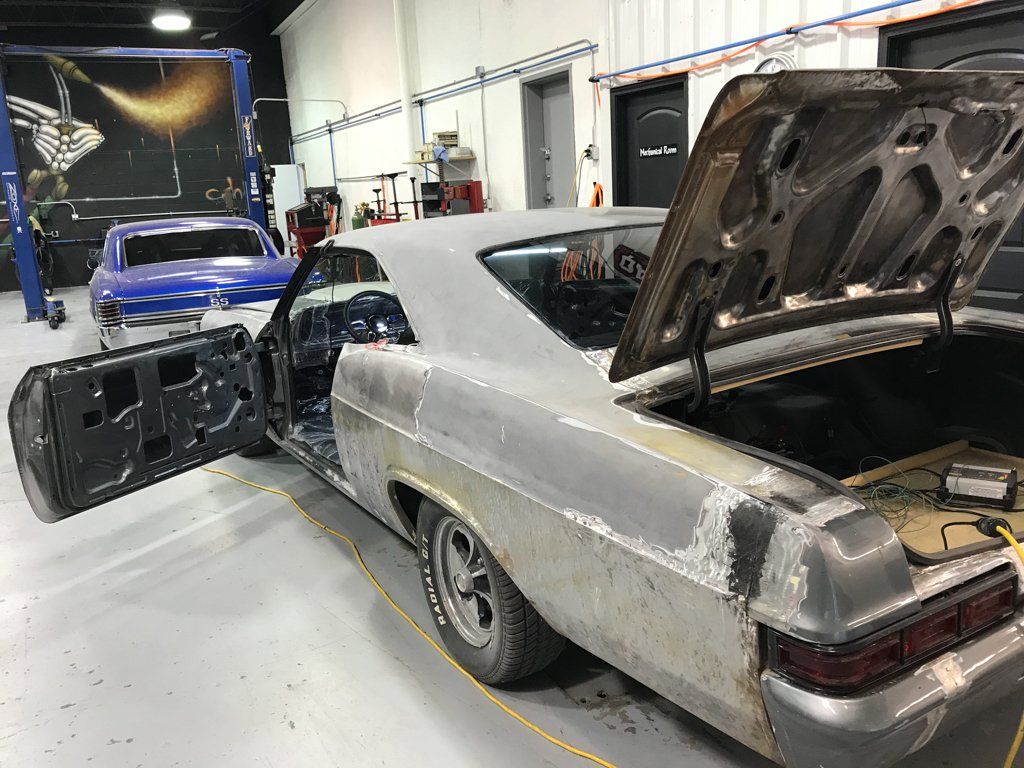 rear side view of car with door and trunk open