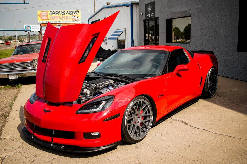 customized 2006 red chevy corvette car with hood open