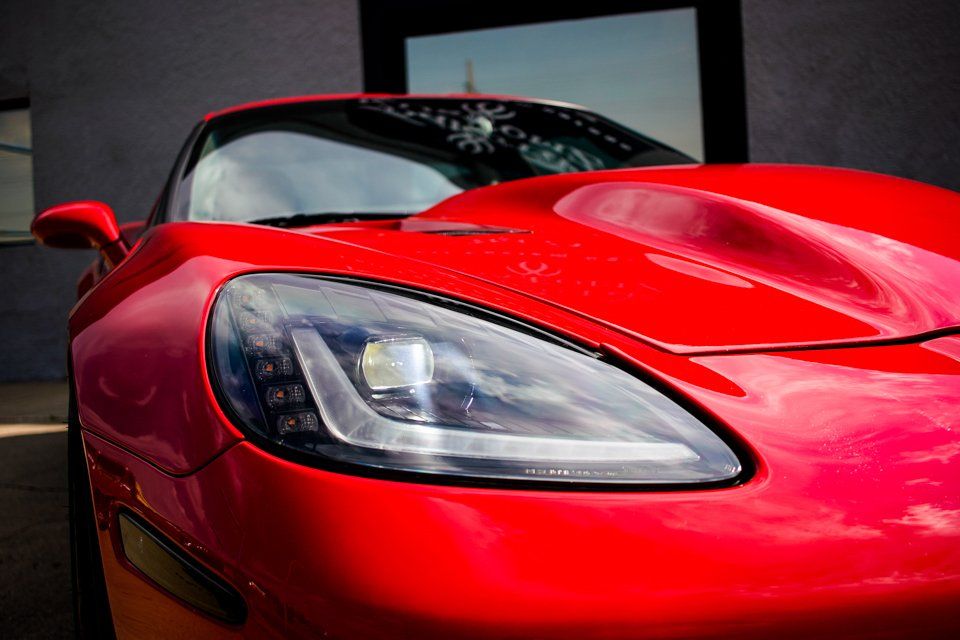 close up of custom red 2006 corvette car headlight