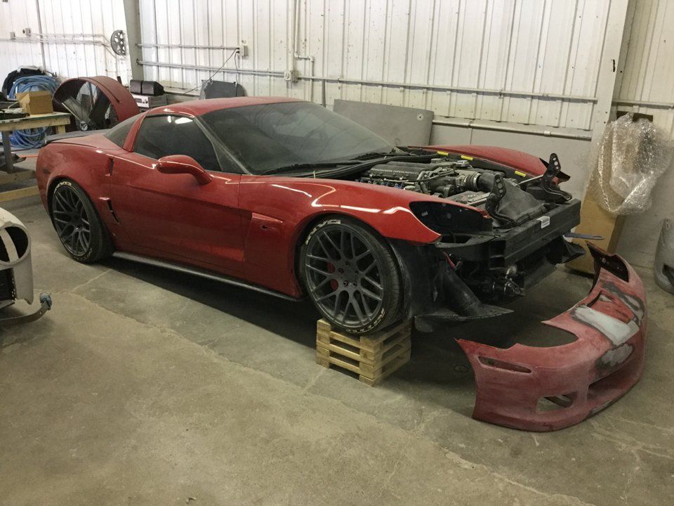 red corvette with hood and front fender removed