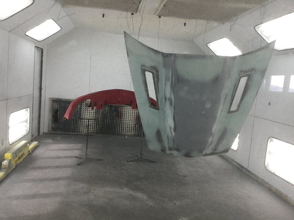 front fender and hood of corvette in painting room