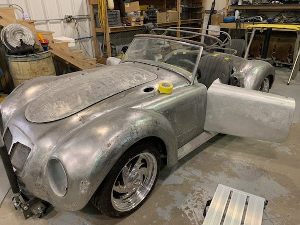 front view of car with door open in garage
