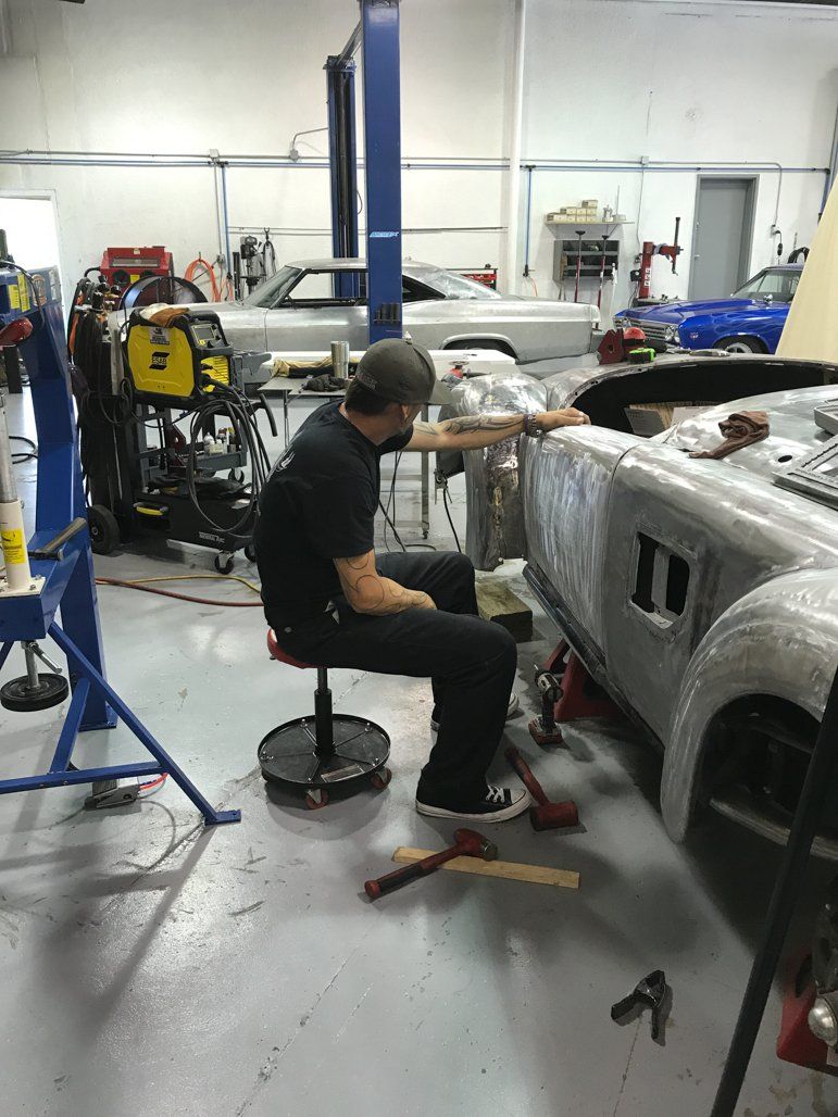 sitting working inspecting car