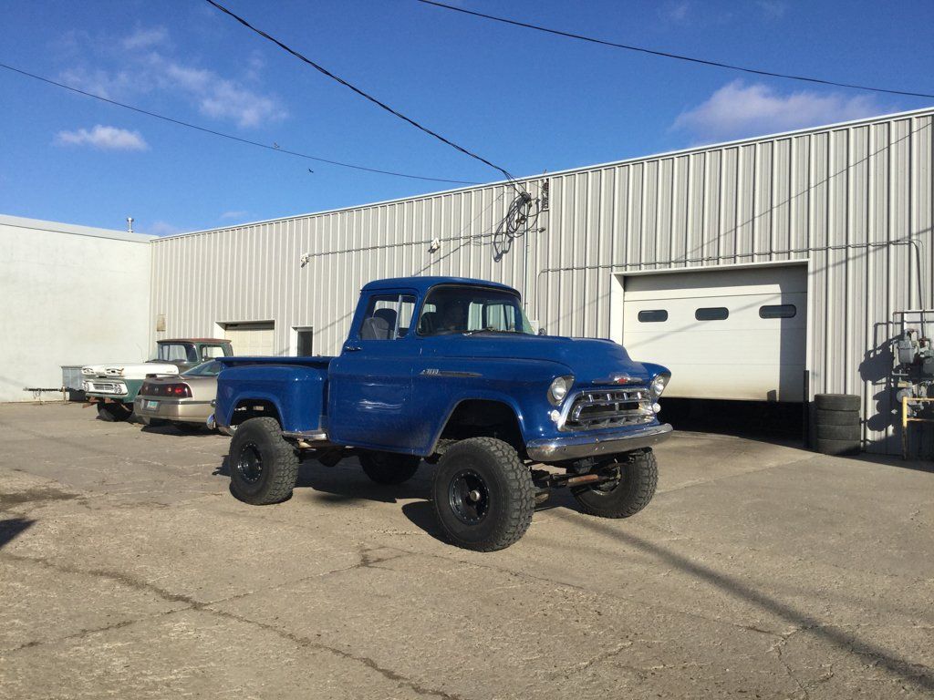 front side view of truck outside in front of garage door