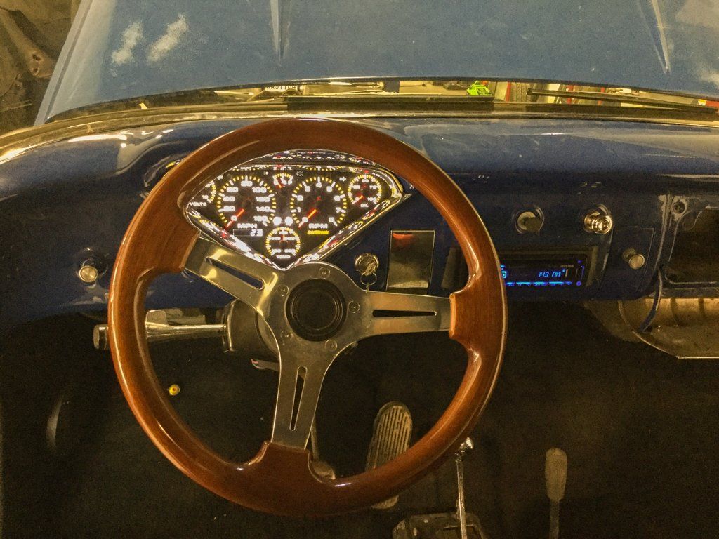 brown steering wheel and lit-up dashboard