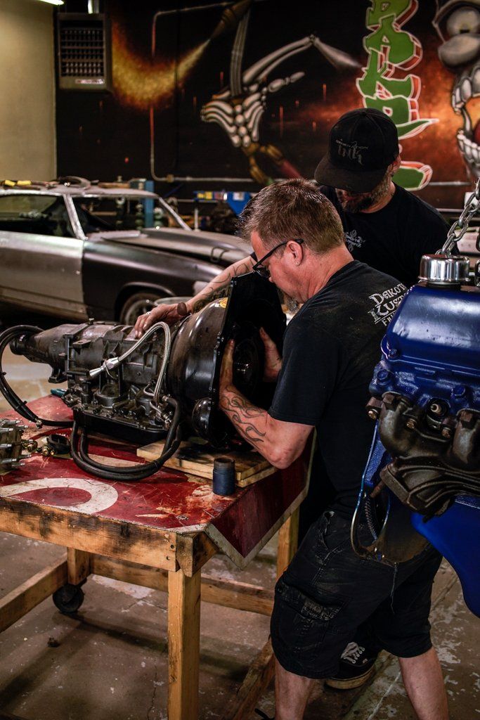 mechanics working on detailing car parts