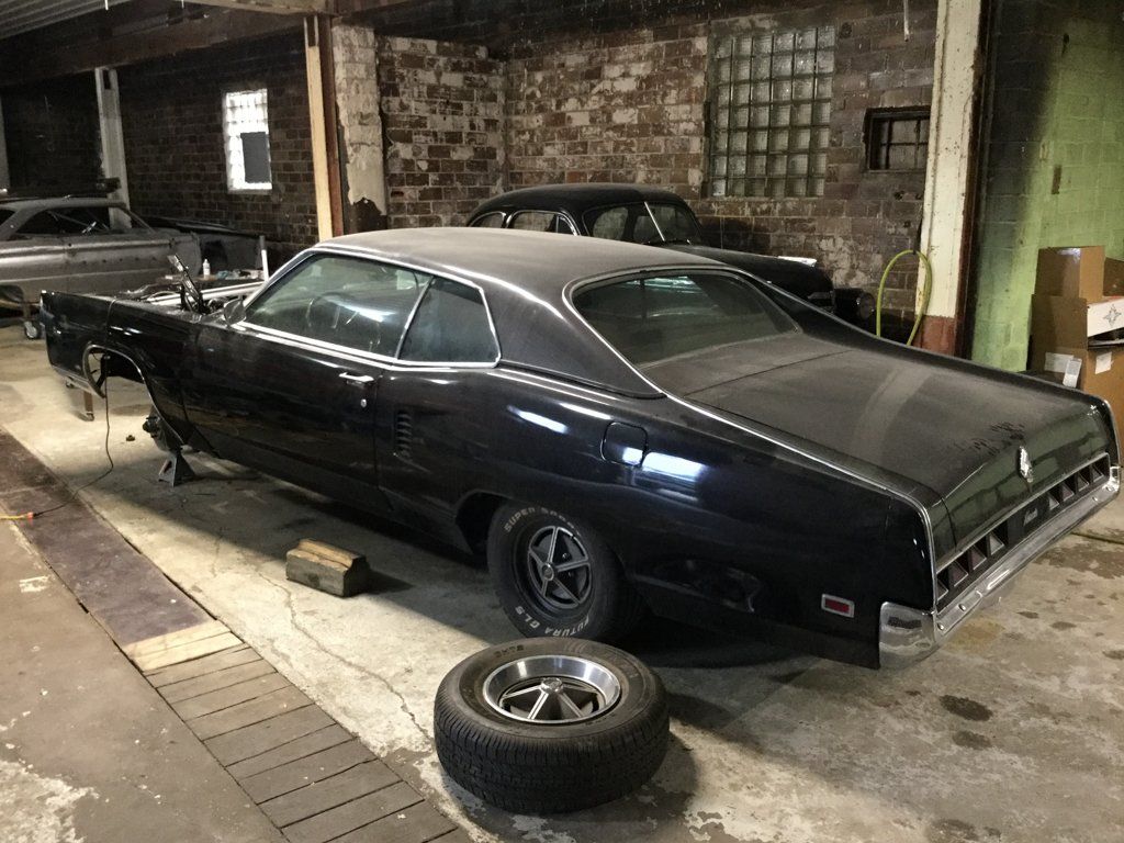 side rear view of car with front tires removed