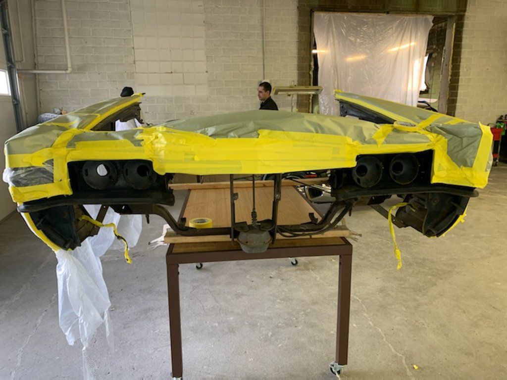 car part removed and covered in yellow tape for detailing