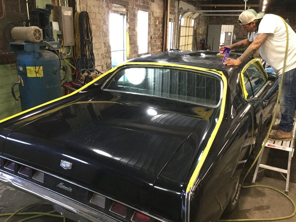 rear view of car with yellow tape on trunk