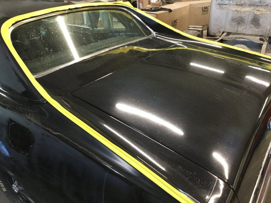 rear of car with yellow tape on trunk