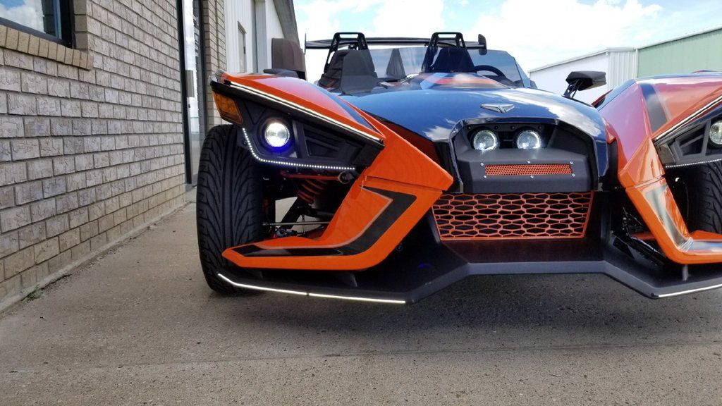 close up of custom orange and black polaris slingshot