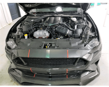 black dodge charger with hood open displaying supercharger