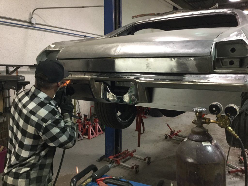 mechanic detailing rear fender